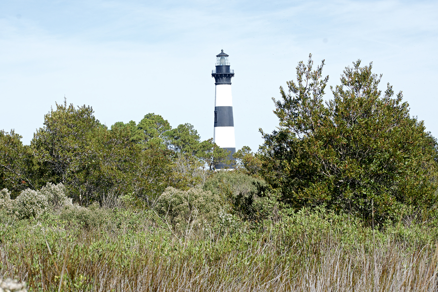 Bodie Island Lighthouse from the maritime forest on the south side. Bodie Island Lighthouse from the maritime forest on the south side.