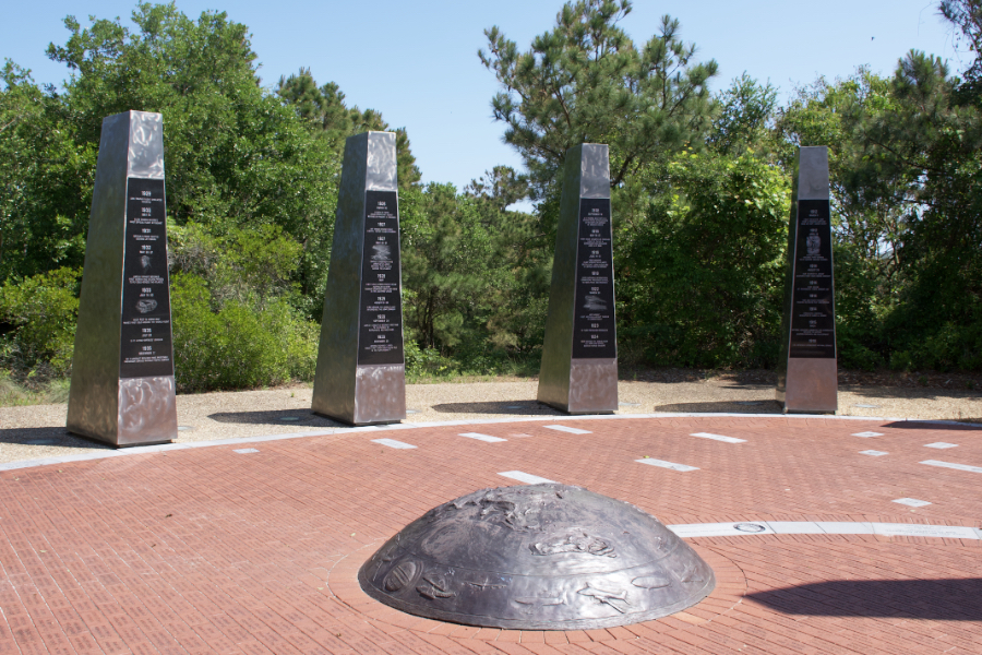 The Monument to a Century of Flight is hidden behind the Aycock Brown Welcome Center in Kitty Hawk. The Monument to a Century of Flight is hidden behind the Aycock Brown Welcome Center in Kitty Hawk.